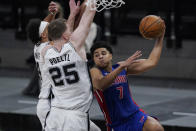 Detroit Pistons guard Killian Hayes (7) drives to the basket against San Antonio Spurs center Jakob Poeltl (25) and guard Derrick White (4) during the second half of an NBA basketball game in San Antonio, Thursday, April 22, 2021. (AP Photo/Eric Gay)