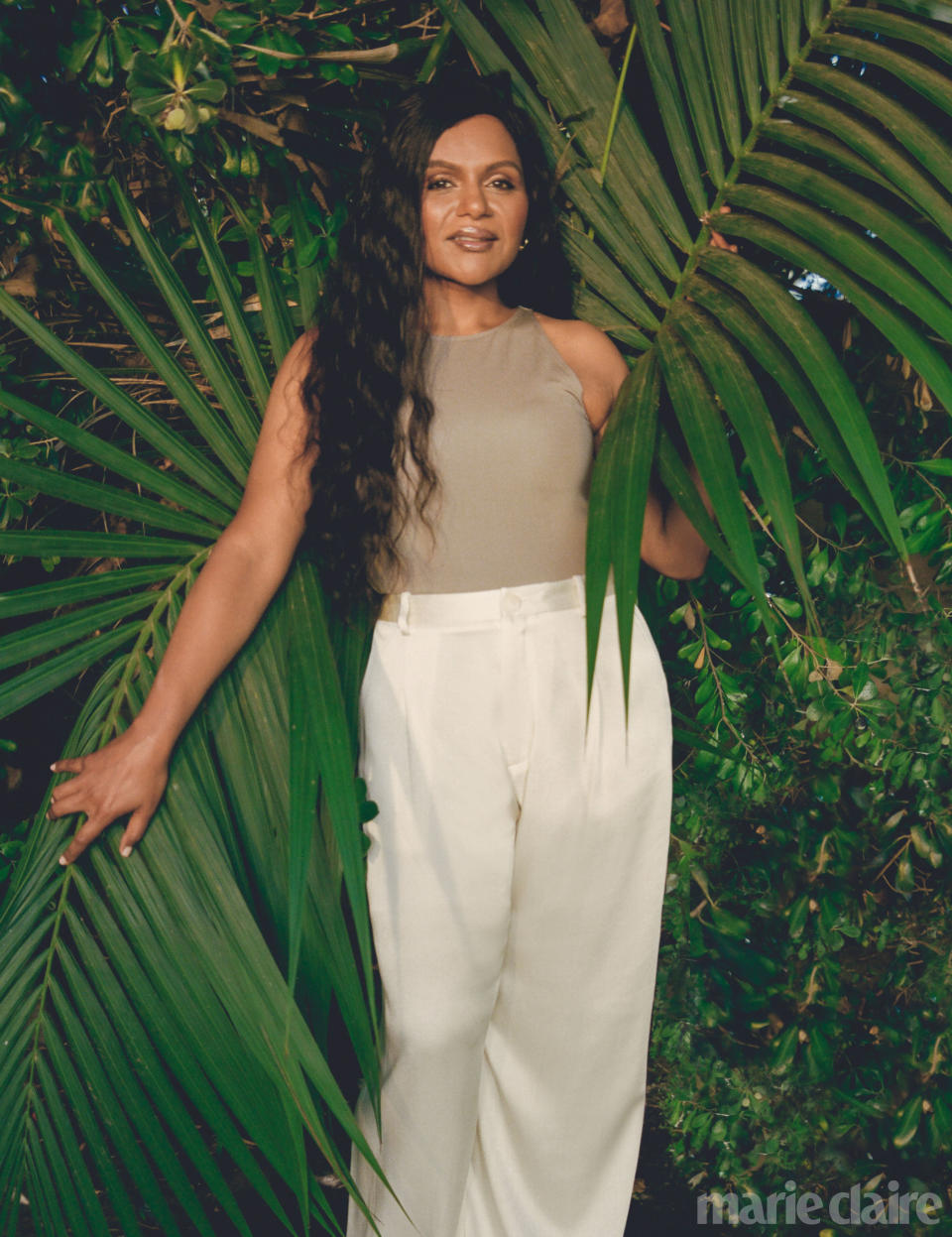 Mindy Kaling poses with palm fronds