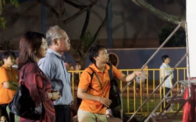 Nicole Seah's parents, Leonard Seah and Pat Lim, and boyfriend/campaign manager Belmont Lay waiting for her to make her speech. (Yahoo! photo/Alicia Wong)