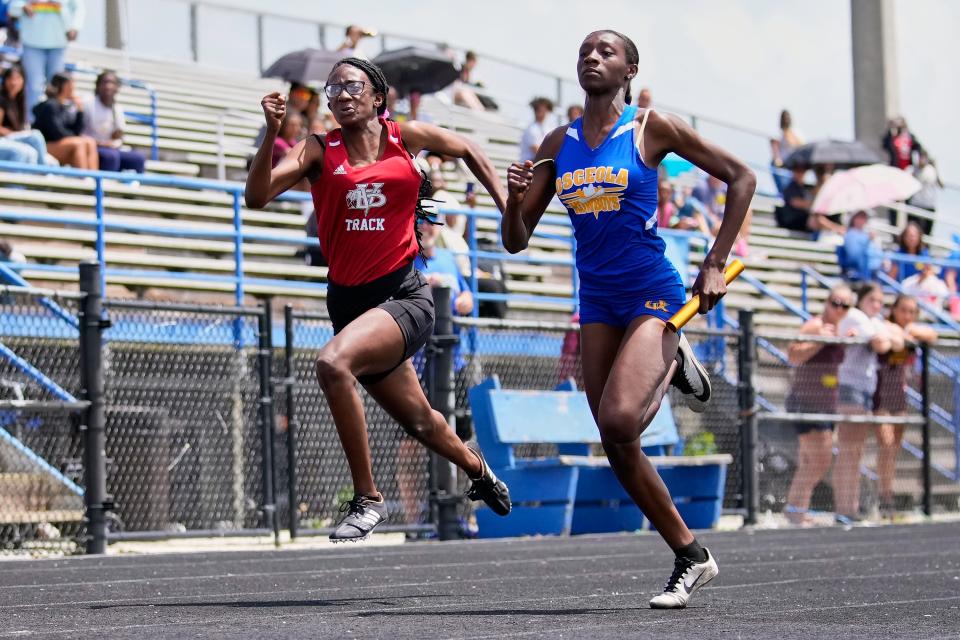 Vero Beach's Brianna Carter (left) competes in the girls 4 x 100-meter race during the District 10-4A Track and Field Championship on Friday, April 22, 2022 at Martin County High School in Stuart. 