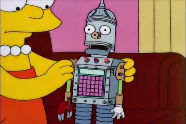 Lisa sits on the couch, holding a robot with a magnet hand a keypad on his chest