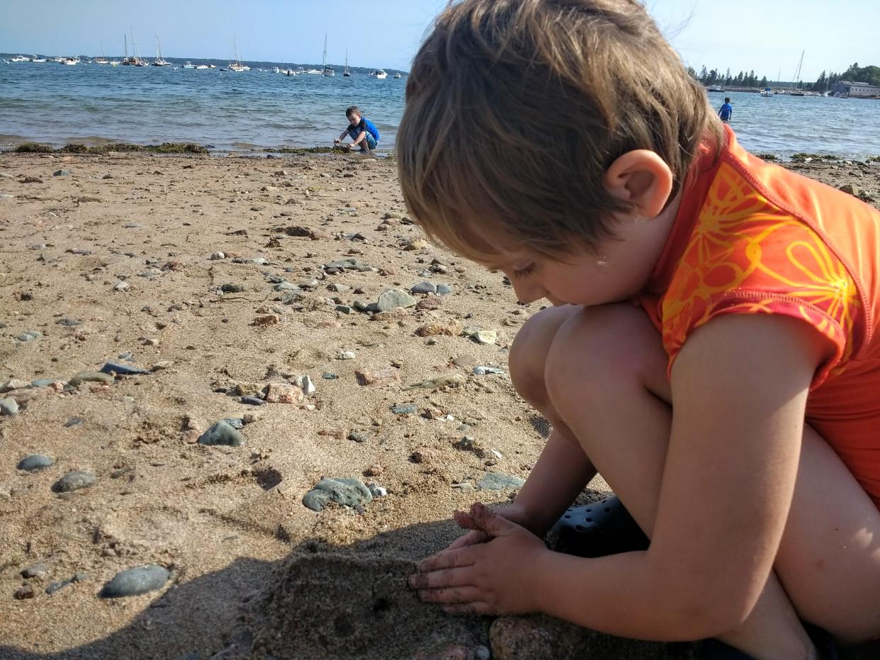 Alyssa Walker's daughter builds a sandcastle in the foreground with her son in the background. (Photo: Courtesy of Alyssa Walker)