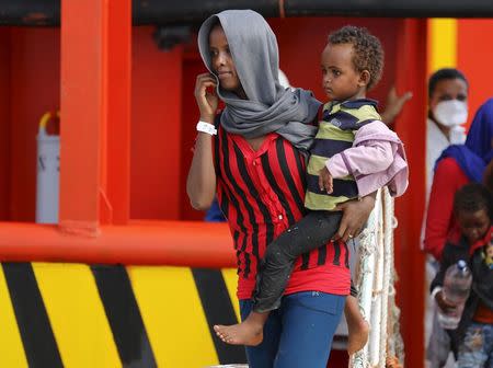 Migrants disembark from a merchant ship in the Sicilian harbour of Pozzallo, Italy August 2, 2015. REUTERS/Antonio Parrinello