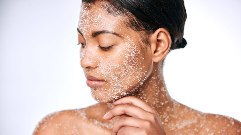 Woman exfoliating skin