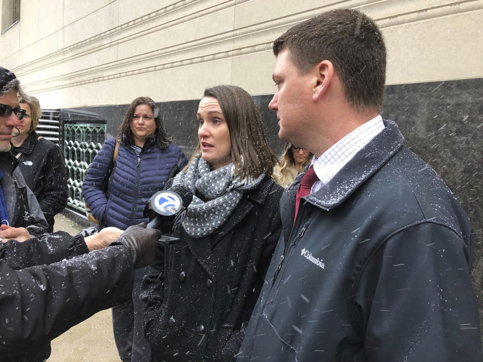 Chrystal Laughlin and husband Jason Laughlin, of Lexington, S.C., speak to reporters outside U.S. District Court in Detroit, Wednesday, Feb. 26, 2020. They were among the victims of Tara Lee, a suburban Detroit woman who was sentenced to 121 months in prison for committing fraud in arranging adoptions. (AP Photo/Ed White)
