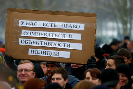 FILE PHOTO: Activists and supporters of the 'International Convention of German Russians' protest against sexual harassment by migrants in front of the Chancellery in Berlin, Germany, January 23, 2016. The placard reads 'We have right to question the objectivity of police.' REUTERS/Hannibal Hanschke