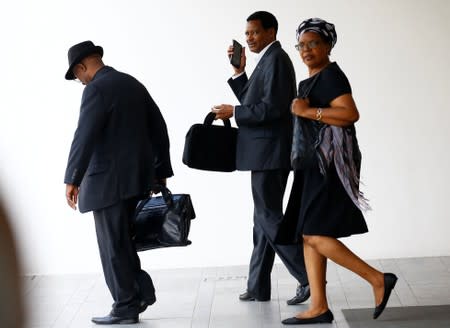 Zimbabwe's charge d'affaires Claudius Nhema and other visitors leave after attending a private religious service at Singapore Casket, the funeral parlour where the body of the late former Zimbabwe's President Robert Mugabe is being held in Singapore