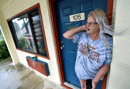 Rachel Ellison stands in the doorway to her apartment at the Lighthouse Motel, where she planned to ride out Hurricane Michael, in Panacea, Florida, U.S., October 10, 2018. REUTERS/Steve Nesius