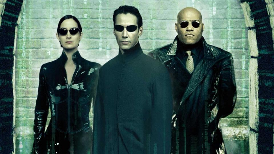 Carrie Anne Moss, Keanu Reeves, and Laurence Fishburne in the poster for The Matrix Reloaded.