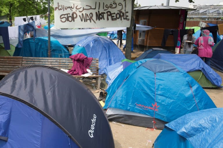 Refugees and migrants are pictured in a makeshift camp in Paris on May 27, 2016