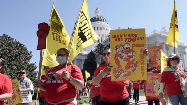 PHOTO: Fast food workers and their supporters march past the state Capitol calling on passage of a bill to provide increased power to fast-food workers, in Sacramento, Calif., Aug. 16, 2022.  (Rich Pedroncelli/AP)