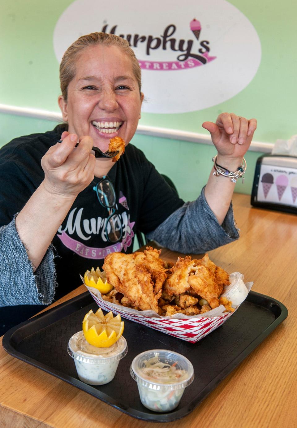 Chef Rocio Medrano enjoys the fisherman's platter (haddock, full-belly clams, scallops, onion rings and french fries) at Murphy's Eats & Treats on Edgell Road in Framingham, Feb. 21, 2024.