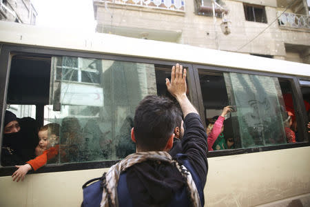 A man gestures as people are evacuated in the besieged town of Douma, Eastern Ghouta, in Damascus, Syria March 19, 2018. REUTERS/Bassam Khabieh