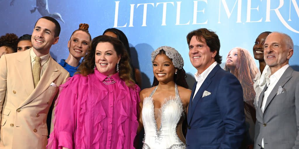 actors from the little mermaid embracing for a photo