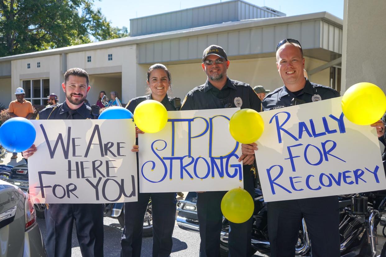 Tallahassee Police Officers support their injured colleague Oct. 18, 2023, as he walks out of rehab.