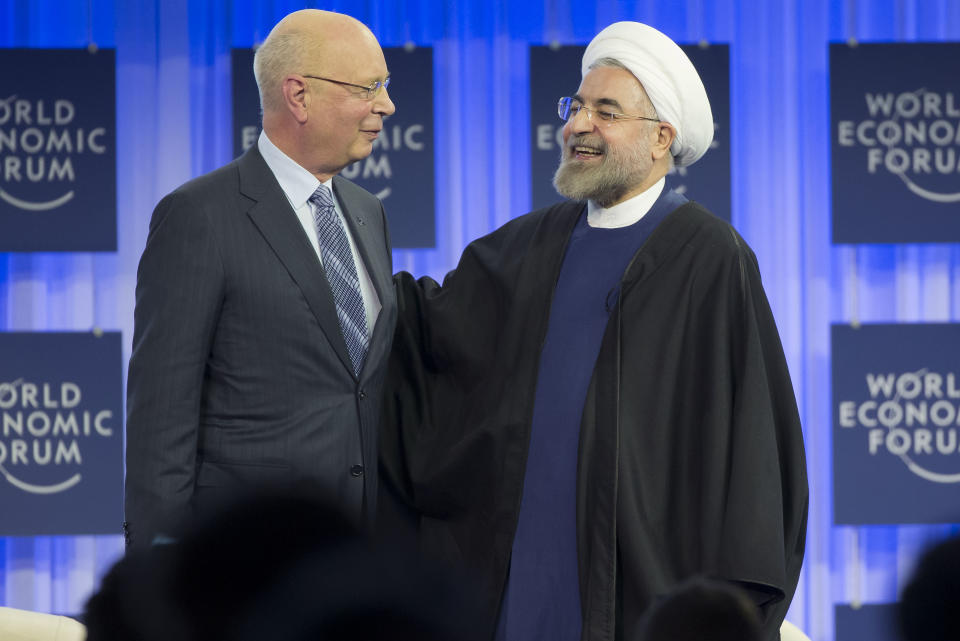 Founder and President of the World Economic Forum Klaus Schwab, left, and Iranian President Hassan Rouhani, share a word after a session of the World Economic Forum in Davos, Switzerland, Thursday, Jan. 23, 2014. Leaders gathered in the Swiss ski resort of Davos have made it a top priority to push to reshape the global economy and cut global warming by shifting to cleaner energy sources. (AP Photo/Michel Euler)