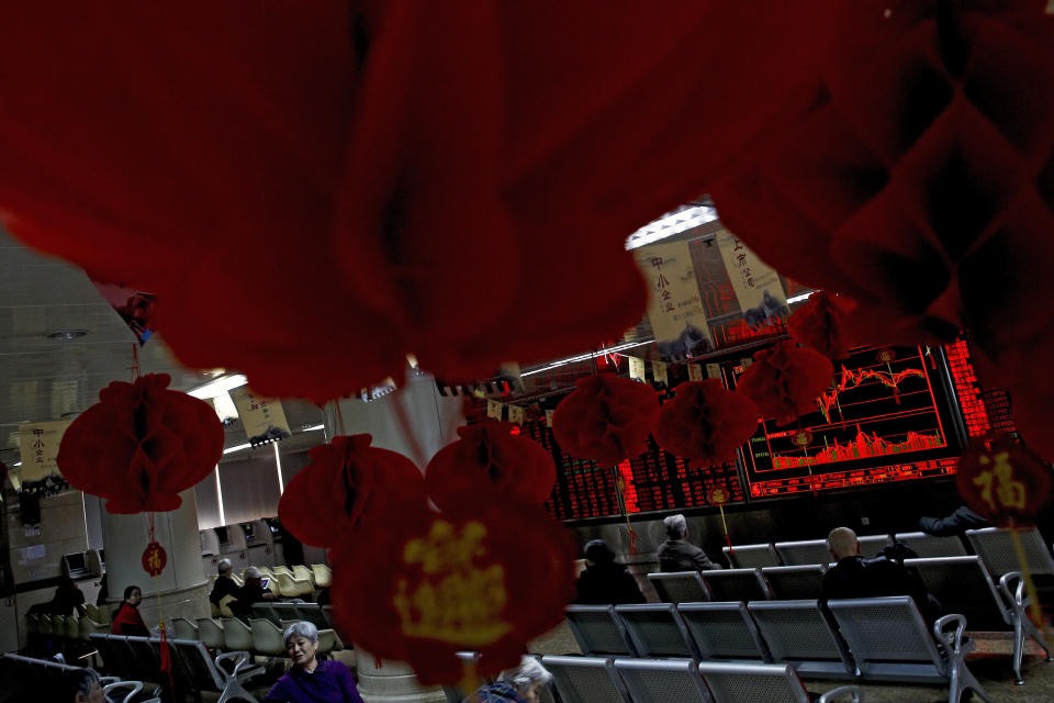 Investors monitor stock prices at a brokerage house decorated with red lanterns in Beijing, Friday, Feb. 1, 2019. Asian markets were mixed on Friday as trade talks ended in Washington with no deal but the promise of a second meeting between U.S. President Donald Trump and Chinese leader Xi Jinping. Gains were limited by a private survey showing that Chinese manufacturing slowed to the lowest level in almost three years. (AP Photo/Andy Wong)