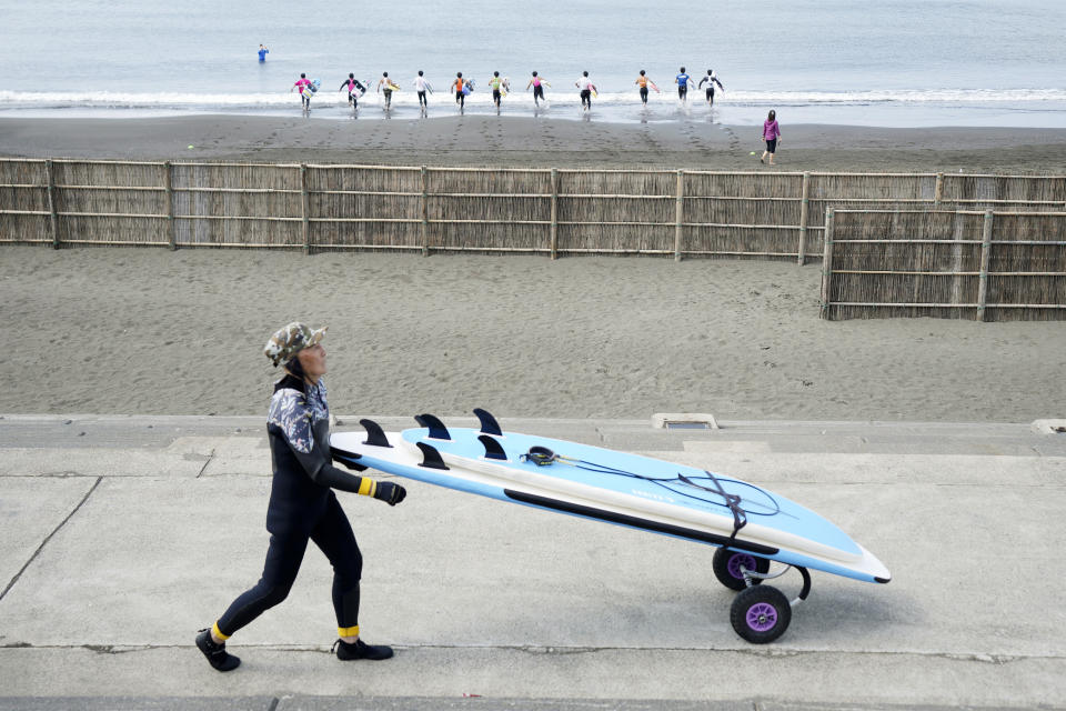 Seiichi Sano, an 89-year-old Japanese man, prepares to ride a wave at Katase Nishihama Beach, Thursday, March 30, 2023, in Fujisawa, south of Tokyo. Sano, who turns 90 later this year, has been recognized by the Guinness World Records as the oldest male to surf. (AP Photo/Eugene Hoshiko)