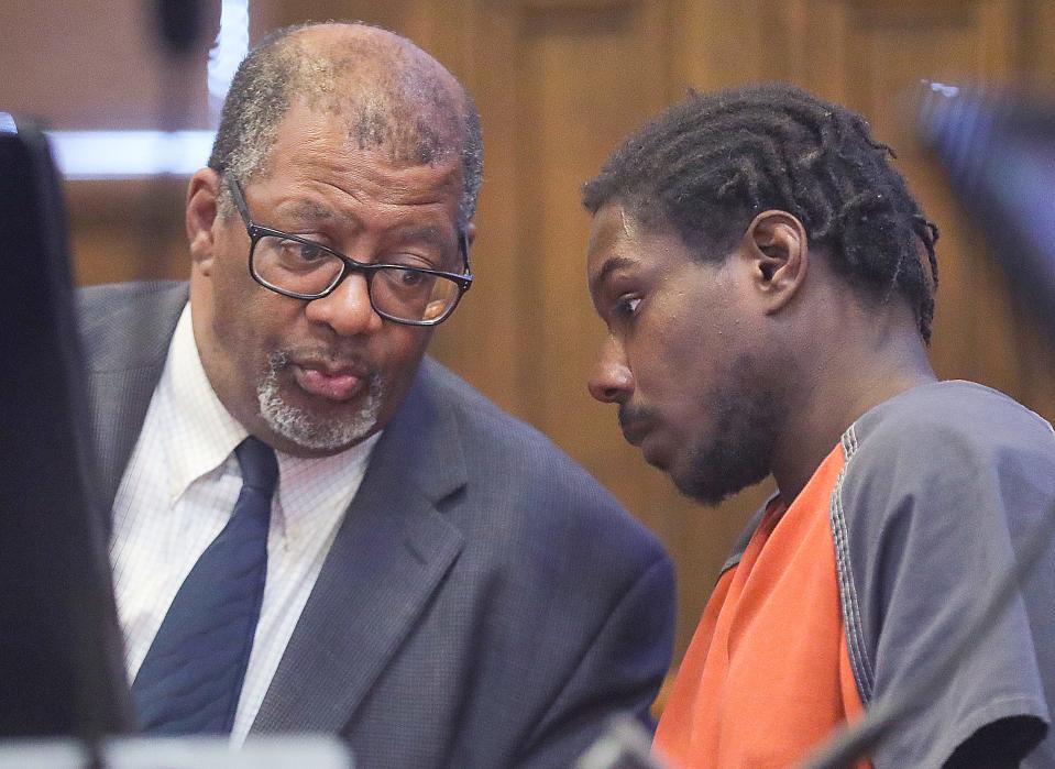 Defense attorney Ed Smith talks with Kahlyl Powe during a competency hearing before Judge Alison McCarty on Aug. 9 in Akron.