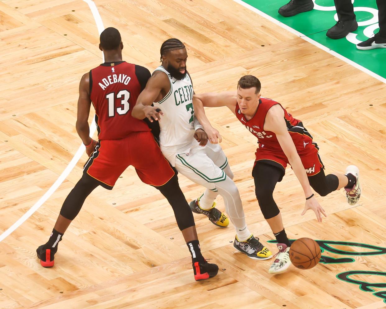 Miami Heat's Duncan Robinson, right, goes around Boston's Jaylen Brown as teammate Bam Adebayo sets a screen during Game 2 of the Eastern Conference Finals last Friday at TD Garden.