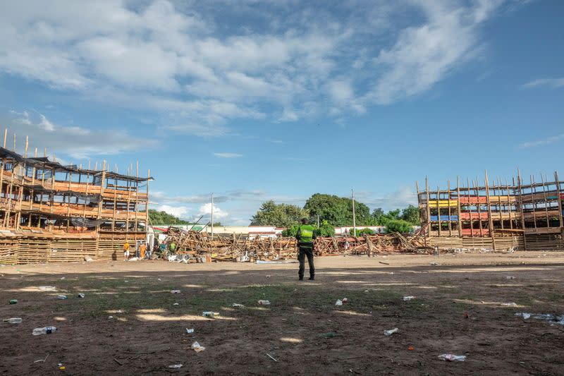 A police officer stands inside a bullring where some stands collapsed during the celebration of the San Pedro festivities, in El Espina