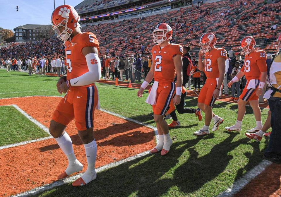 Nov 26, 2022; Clemson, SC, USA; Clemson quarterback D.J. Uiagalelei (5), left, quarterback Cade Klubnik (2), quarterback Hunter Johnson (12), and quarterback Hunter Helms (18) walk on the field for pregame practice, before the game between South Carolina and Clemson at Memorial Stadium in Clemson, S.C. Saturday, Nov. 26, 2022.