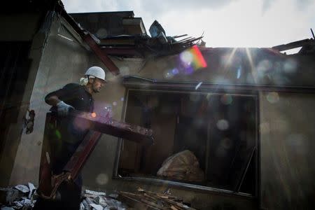 Kurdish man works at a demolition site in Chiba east of Tokyo, October 21, 2015. REUTERS/Thomas Peter