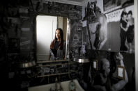 Argentine tango dancer and director Mora Godoy poses for a picture in her bathroom decorated with pictures of her dancing in Buenos Aires, Argentina, Wednesday, June 2, 2021. “It is very painful not to be able to dance,″ said Godoy, adding that some tango professionals had turned to taxi-driving and selling groceries to make a living during the COVID-19 pandemic lockdown. (AP Photo/Natacha Pisarenko)