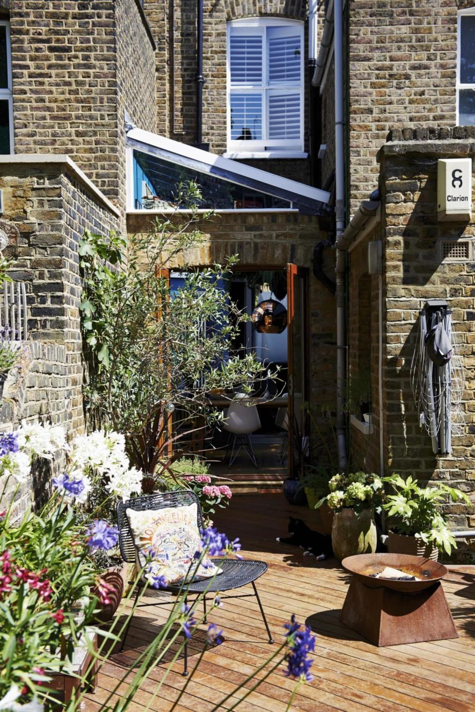 The garden, with potted plants and a fire pit