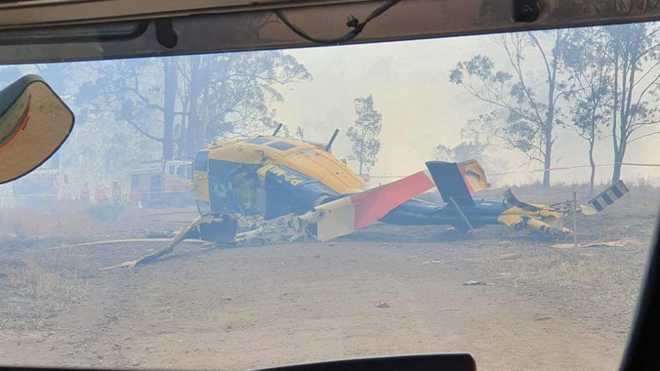 The crumpled helicopter is seen sitting heaped on the ground. Source: supplied
