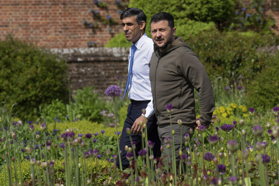 FILE - Britain's Prime Minister Rishi Sunak, left, and Ukraine's President Volodymyr Zelenskyy, walk in the garden at Chequers, the prime minister's official country residence, in Aylesbury, England, Monday, May 15, 2023. The symbolism will be palpable when leaders of the world’s rich democracies sit down in Hiroshima later this week. The Japanese city's name evokes the tragedy of war, and the leaders will tackle a host of challenges including Russia’s invasion of Ukraine and rising tensions in Asia. (Carl Court/Pool via AP, File)
