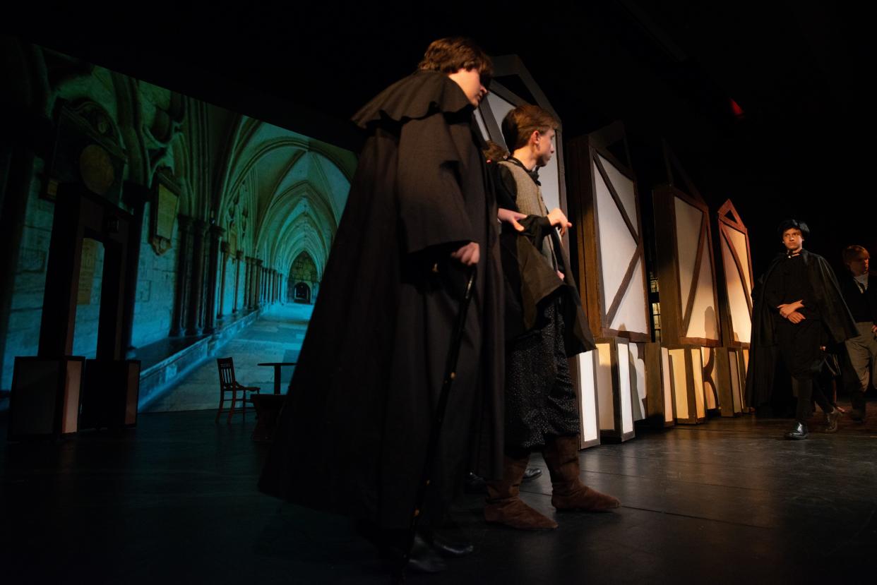 The lights slowly come up revealing characters entering a period building on the stage at Washburn Rural as the high school theater troupe rehearse "The Book of Will" Friday.