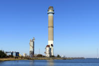 The smokestack at the former B.L. England power plant stand in Upper Township, N.J., before a control demolition, Thursday, Oct. 26, 2023. The site will be redeveloped as a mixed use residential and commercial project, and a nearby electrical substation will be used to connect New Jersey's soon-to-come offshore wind farms with the electrical grid. (AP Photo/Wayne Parry)