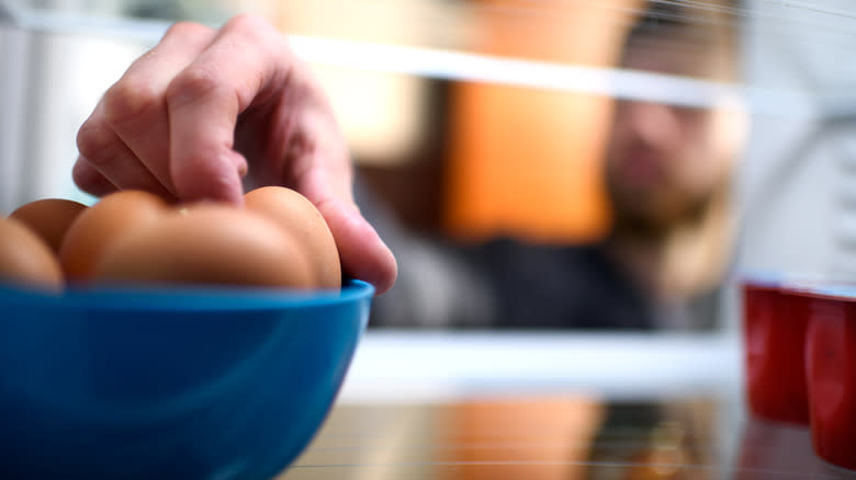 Grabbing eggs from fridge