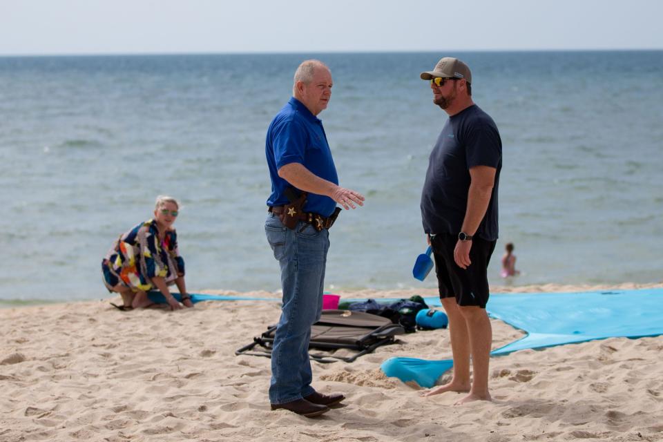 Franklin County Sheriff's Office Major of Patrol Dwayne Coulter speaks with a beach-goer about illegal parking on St. George Island on Thursday, March 14, 2024.