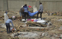 Relatives prepare to cremate COVID-19 victims at a ground that has been converted into a crematorium in New Delhi, India, Saturday, May 1, 2021. India on Saturday set yet another daily global record with 401,993 new cases, taking its tally to more than 19.1 million. Another 3,523 people died in the past 24 hours, raising the overall fatalities to 211,853, according to the Health Ministry. Experts believe both figures are an undercount. (AP Photo/Amit Sharma)