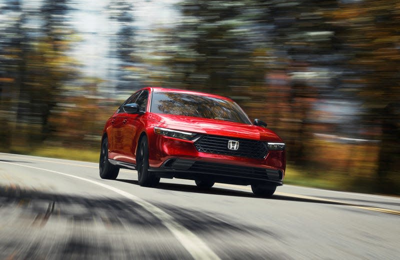 A red Honda Accord driving on a fun road