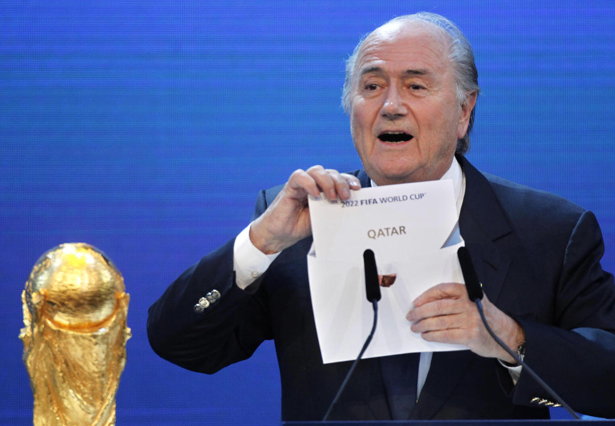 FILE - In this Thursday, Dec.2, 2010 file photo FIFA President Sepp Blatter announces Qatar to host the 2022 soccer World Cup in Zurich, Switzerland. FIFA has cleared Russia and Qatar of any wrongdoing in their winning bids for the next two World Cups. (AP Photo/Michael Probst)