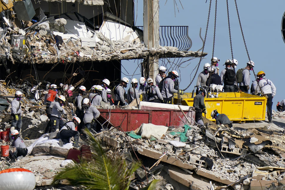 Workers search the rubble at the Champlain Towers South Condo, Monday, June 28, 2021, in Surfside, Fla. Many people were still unaccounted for after Thursday's fatal collapse. (AP Photo/Lynne Sladky)