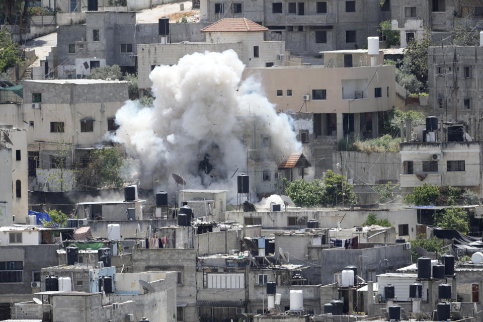 Smoke rises from an explosion during an Israeli military raid in the Nur Shams refugee camp, near the West Bank town of Tulkarem, Saturday, April 20, 2024. The raid killed at least four Palestinians, including three militants, according to the Israeli military, Palestinian health officials and the Islamic Jihad militant group. Palestinian health authorities said one of those killed was a 15-year-old boy shot dead by Israeli fire. The Israeli military said four Israeli soldiers were slightly wounded in the operation. (AP Photo/Majdi Mohammed)