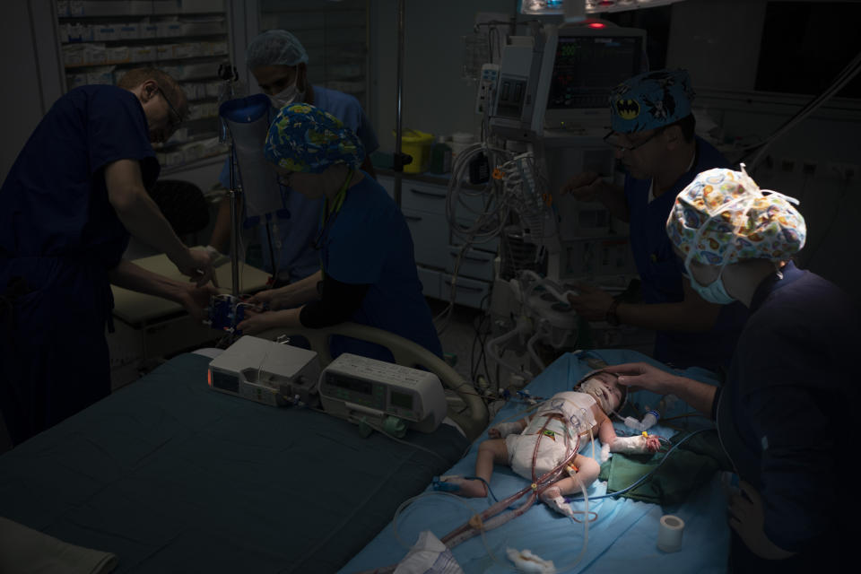 Nurse Martina Pavanic, right, and other members of the Novick Cardiac Alliance medical team prepare to bring 40-day-old Yaqen out of the operating room after her heart surgery at the Tajoura National Heart Center in Tripoli, Libya, on Feb. 25, 2020. (AP Photo/Felipe Dana)