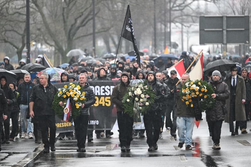 Participants in a march by right-wing extremists walk through the southern suburbs of Dresden to mark the 79th anniversary of the destruction of Dresden in World War II on 13 February 1945. Robert Michael/dpa