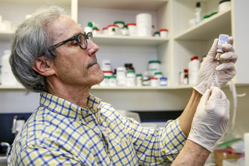 La Canada Flintridge, CA - November 16: Michael Stremfel, owner of the pharmacy, prepares a boaster shot of Moderna vaccine for Covid19 at Flintridge Pharmacy on Tuesday, Nov. 16, 2021 in La Canada Flintridge, CA. (Irfan Khan / Los Angeles Times)