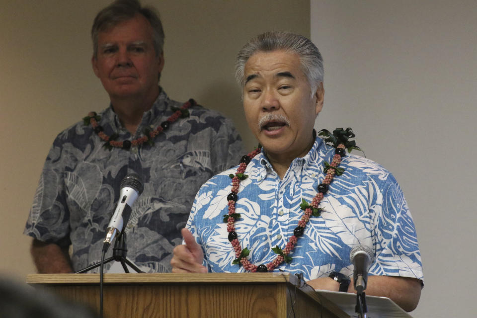 FILE - In this March 3, 2020 file photo Gov. David Ige speaks to reporters at the state Department of Health's laboratory in Pearl City, Hawaii. Ige signed a proclamation ordering state residents to stay home from March 25 through April 30, exempting workers deemed essential. Observatories on Hawaii's tallest mountain have shut down operations in response to the governor's stay-at-home order aimed at preventing the spread of the coronavirus. The director of Canada-France-Hawaii Telescope says some scientific discoveries are likely to be lost during this time. (AP Photo/Audrey McAvoy, File)