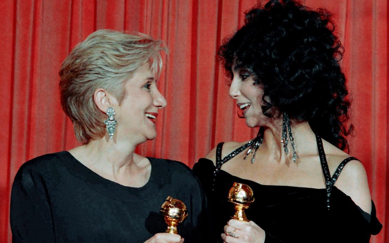 Dukakis with Cher at the Golden Globes in 1988 - AP