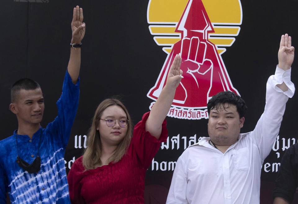 Pro democracy student leaders of United Front of Thammasat and Demonstration, from left Panupong Jadnok, Panusaya Sithijirawattanakul, and Parit Chiwarak raise a three-fingers salute, a symbol of resistance after announcing the pro-democracy movement's rally scheduled for Sept. 19, 2020 at Thammasat University Bangkok, Thailand, Wednesday, Sept. 9, 2020. A two-day rally planned for this weekend is jangling nerves in Bangkok, with apprehension about how far student demonstrators will go in pushing demands for reform of Thailand’s monarchy and how the authorities might react. More than 10,000 people are expected to attend the Saturday-Sunday event. (AP Photo/Sakchai Lalit)