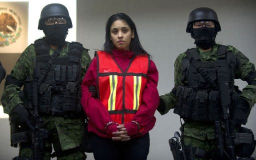 Mexican Army soldiers guard Irasema Lopez Garza, partner of Carlos Oliva Castillo, aka "La Rana", alleged leader of the Zetas in the states of Coahuila, Nuevo Leon y Tamaulipas, in Mexico City, in 2011. The high mortality rate in Mexico's drug war has seen women progress quickly in the shadowy underworld of the cartels and they are increasingly taking on key management roles, a new book says