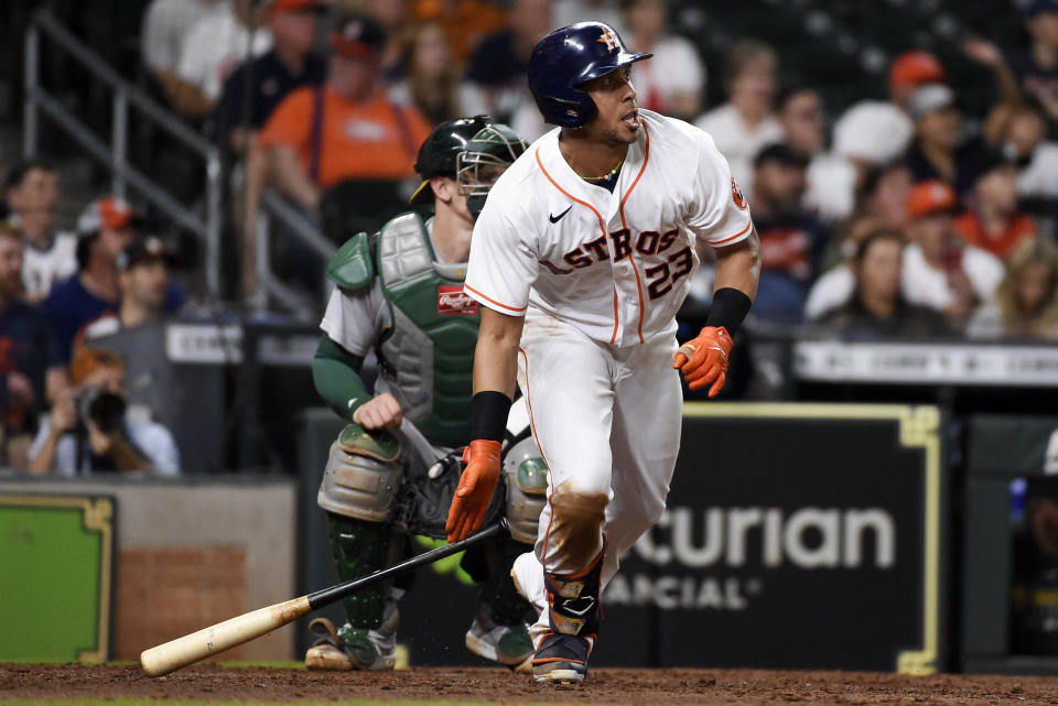 Houston Astros' Michael Brantley hits a two-run triple during the sixth inning of a baseball game against the Oakland Athletics, Saturday, Oct. 2, 2021, in Houston. (AP Photo/Eric Christian Smith)