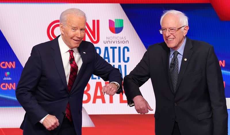 Democratic U.S. presidential candidates Senator Bernie Sanders and former Vice President Joe Biden greet each other before the 11th Democratic candidates debate of the 2020 U.S. presidential campaign in Washington