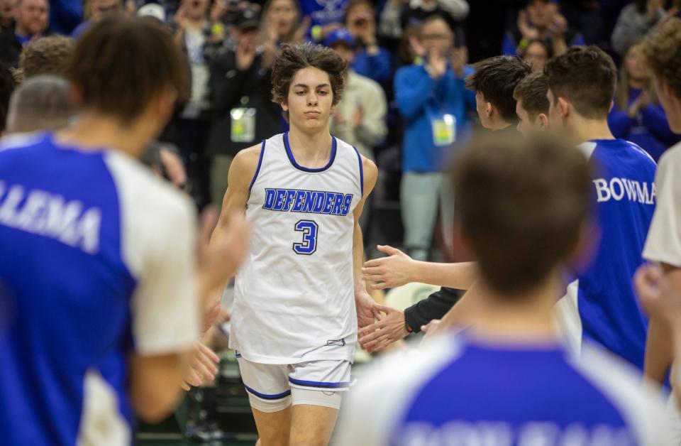 Wyoming Tri-unity Christian's Jordan VanKlompenberg (3) is greeted by his teammates before the start of the game against Mt. Pleasant Sacred Heart during the MHSAA Div. 4 state finals at the Breslin Center in East Lansing on March 16, 2024.